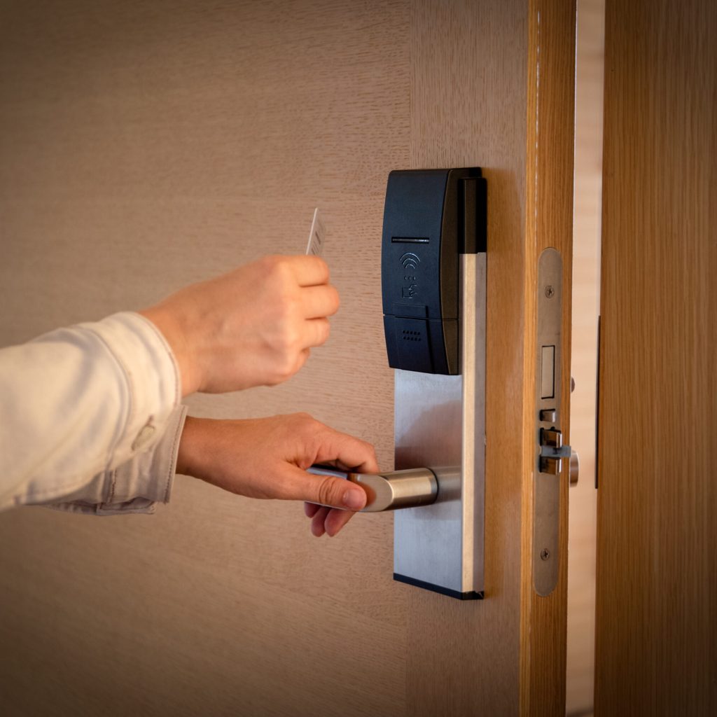 Opening a hotel door with keyless entry card. Opening a hotel door with keyless entry card.